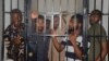 Protesters stand in a cell after a court hearing in Abuja, Nigeria, Sept. 2, 2024. 