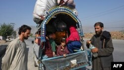 Afghan nationals are pictured along a road in the Jamrud area of Khyber district, 30 km west of Peshawar, Oct. 6, 2023, as they return to Afghanistan following the Pakistan's government decision to expel people illegally staying in the country.