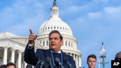 Representative George Santos of New York faces reporters at the Capitol in Washington, Nov. 30, 2023. After a scathing report by the House Ethics Committee citing egregious violations, Santos could be expelled from Congress this week.