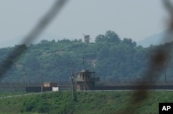 Pos penjagaan militer Korea Utara, latar belakang, dan pos Korea Selatan, depan, terlihat di Paju Korea Selatan, 20 Juli 2023. (AP Photo/Ahn Young-joon)