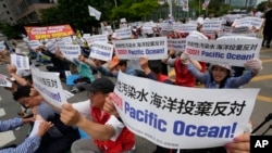 South Korean fishermen stage a rally against the planned release of treated radioactive water from the wrecked Fukushima nuclear power plant, in front of the National Assembly in Seoul, South Korea, Monday, June 12, 2023. (AP Photo/Ahn Young-joon)