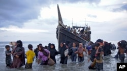Ethnic Rohingya disembark from their boat upon landing in Ulee Madon, North Aceh, Indonesia, Nov. 16, 2023. 