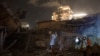 People look at the damage from a rocket fired from the Gaza Strip in Tel Aviv, Israel, Oct. 7, 2023. 
