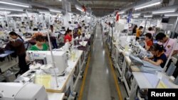 FILE - Laborers work at TAL garment factory in Vinh Phuc province, Vietnam, May 23, 2017.