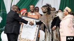 King Misuzulu Zulu, 48, receives the certifcate of recognition from South African President Cyiril Ramaphosa during the kings coronation at the Moses Mabhida Stadium in Durban, Oct. 29, 2022.