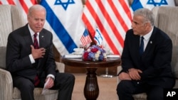 President Joe Biden, left, and Israeli Prime Minister Yair Lapid address the media following their meeting in Jerusalem, July 14, 2022.
