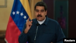 FILE - Venezuela's President Nicolas Maduro speaks during a meeting with ministers at the Miraflores Palace in Caracas, Venezuela, Aug. 13, 2018.