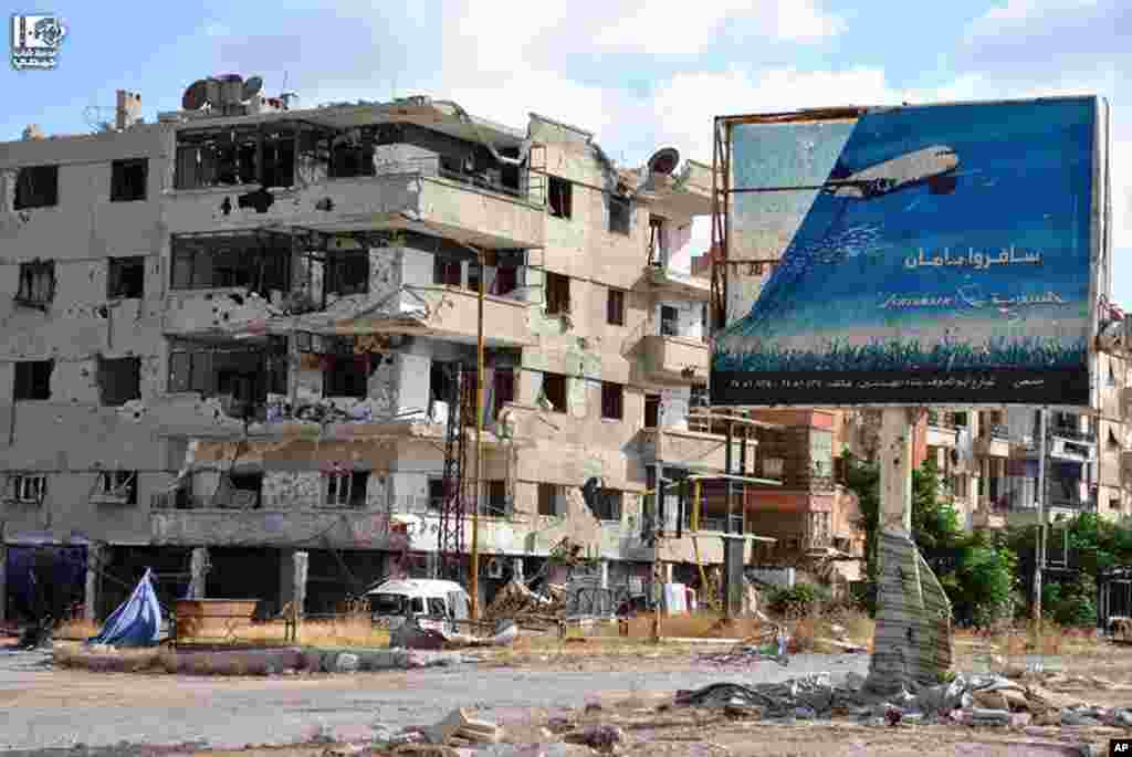 This citizen journalism image provided by Lens Young Homsi shows buildings damaged by fighting between rebel fighters and Syrian government forces in Homs province, Syria, June 18, 2013.