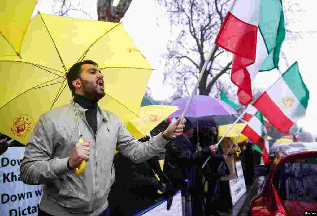 Opponents of Iranian President Hassan Rouhani hold a protest outside the Iranian embassy in west London, Dec. 31, 2017.