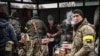 A woman cooks for Ukrainian soldiers at a frontline, northeast of Kyiv on March 3, 2022.