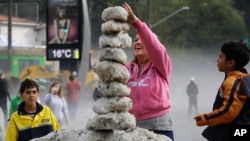 Seorang perempuan membuat menara dari es di wilayah Aclimacao, Sao Paulo, Brazil. Hujan es disertai angin ribut melanda wilayah ini sepanjang malam (19/5).