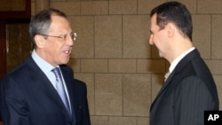 Syrian President Bashar Assad, right, shakes hands with Russian Foreign Minister Sergei Lavrov. (2008 file photo).