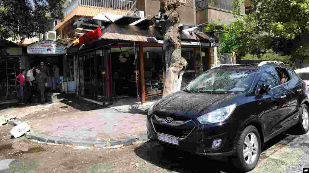  Syrian official news agency (SANA) photo shows a building damaged by what SANA said was a missile in Damascus, Sept. 2, 2013.