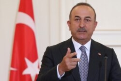 FILE - Turkish Foreign Minister Mevlut Cavusoglu speaks during a joint news conference with his Greek counterpart Nikos Dendias at the Ministry of Foreign Affairs in Athens, Greece, May 31, 2021.
