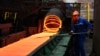 A Chinese employee sorts hot red steel at a steel plant in Zouping in China's eastern Shandong province on March 5, 2018.