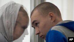 El sargento ruso Vadim Shishimarin escucha a su traductor durante una audiencia en la corte en Kiev, Ucrania, el lunes 23 de mayo de 2022.