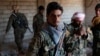 Kurdish fighters from the People's Protection Units (YPG) stand in a house in Raqqa, Syria, June 21, 2017. 