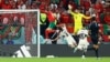 Morocco's Youssef En-Nesyri scores the opening goal against Portugal at the 2022 FIFA World Cup