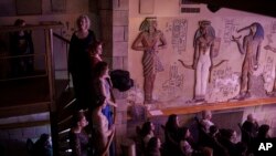 People watch as members of the Kyiv Opera Theater perform the "Christmas in Shelter" concert, on a stage underground in Kyiv, Ukraine, Dec. 24, 2022.