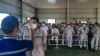 Petugas kesehatan memeriksa suhu tubuh pekerja PT Indonesia Morowali Industrial Park di Morowali, Sulawesi Tengah. BRIN mengatakan pekerja asing China mendominasi jumlah pekerja asing di Tanah Air yang mencapai 44,49 persen dari total pekerja asing. (Foto: AFP)