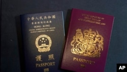 FILE - This Jan. 29, 2021, file photo features a British National (Overseas) passport and a Hong Kong Special Administrative Region of the People's Republic of China passport. 