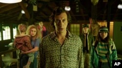 This image released by Netflix shows Adam Driver, center, in a scene from "White Noise." (Wilson Webb/Netflix via AP)