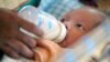 Cambodian orphan Vannak, a 2 month old boy, is fed formula milk by a nanny at Chrey Chao commune orphanage on the outskirts of Phnom Penh, file photo. (AP Photo/Andy Eames)