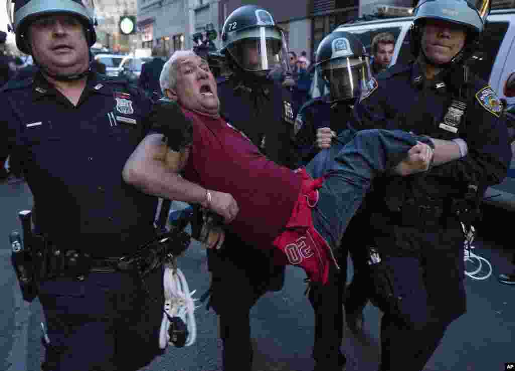 A man is carried by police officers as arrests are made at a protest at New York City's Union Square over the death of Freddie Gray, a Baltimore man who died while in police custody, April 29, 2015.