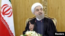 FILE - Iranian President Hassan Rouhani speaks in Tehran. Rouhani ordered his defense minister to expand the ballistic missile program as a response to the threatened U.S. sanctions.