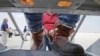 FILE - Shackled Mexican immigrants are boarded onto a U.S. Immigration and Customs Enforcement jet chartered for deportation of illegal immigrants at O'Hare in Chicago, Il., May 25, 2010. 