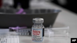 FILE - A vial of the Moderna COVID-19 vaccine is seen at an ambulance company in Santa Fe Springs, California, Jan. 9, 2021.