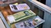 In this Wednesday, May 21, 2019, photo, U.S. and Iranian currency are readied by a money exchanger outside the golden-domed shrine of Imam Moussa al-Kadhim in Kadhimiya district in north Baghdad, Iraq. 