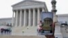 FILE - A Supreme Court visitor takes pictures with her cell phone outside the Supreme Court in Washington.