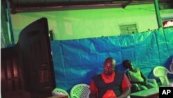 Owner of an open-air bar and restaurant Zakarya Gueme takes notes as partial election results are announced on state television, in central Bouake, the former rebel capital of northern Ivory Coast, 02 Nov 2010