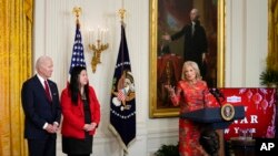 La primera dama Jill Biden habla mientras el presidente Joe Biden y Elaine Tso, directora ejecutiva de Asian Services in Action, escuchan durante una recepción para celebrar el Año Nuevo Lunar en el Salón Este de la Casa Blanca en Washington, el 26 de enero de 2023.
