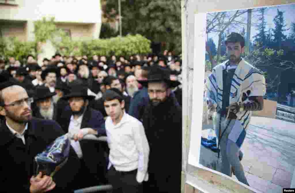 A photograph of Yoav Hattab, killed in an attack on a Paris grocery on Friday, is displayed during a procession before his funeral in Bnei Brak near Tel Aviv, Jan. 13, 2015.
