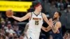 Nikola Jokić u duelu sa Kajlom Andersonom iz Memfisa, u Denveru, 7. aprila 2022. (Foto: AP/David Zalubowski)