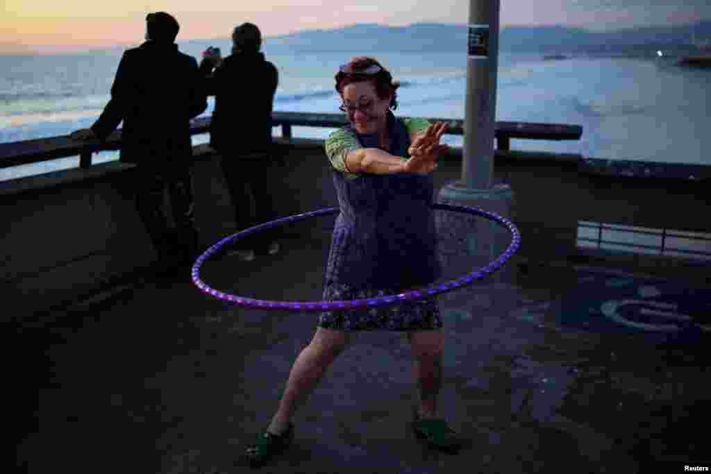 A woman hula hoops along the Venice Pier in Los Angeles, California, Nov. 18, 2024.