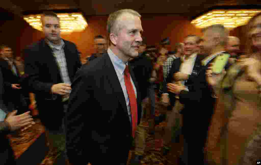 In Alaska, Republican U.S. Senate candidate Dan Sullivan walks to the stage to greet supporters on election night in Anchorage, Nov. 4, 2014.