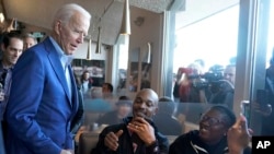 Democratic presidential candidate former Vice President Joe Biden talks with customers at the Buttercup Diner during a campaign stop in Oakland, Calif., March 3, 2020.