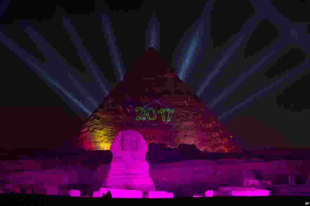 Lights illuminate the historical site of Giza Pyramids and Sphinx to celebrate the New Year in Egypt, Jan. 1, 2017. 