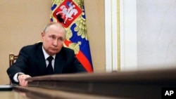 Russian President Vladimir Putin chairs a meeting with members of the government via teleconference in Moscow, March 10, 2022.