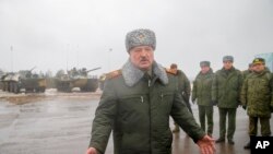Belarusian President Alexander Lukashenko gestures while speaking to journalists at the Osipovichi training ground during Russia-Belarus military drills near Osipovichi, Belarus, Feb. 17, 2022.