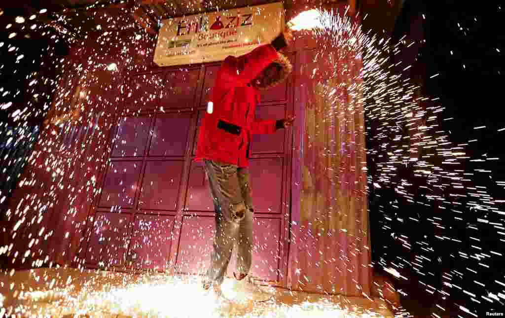 A reveler spins burning-steel wool to spread sparks of fire during the New Year's Eve celebrations in Nairobi, Kenya Jan. 1, 2023.