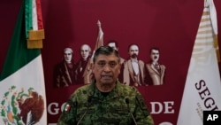 Mexican Defense Secretary Luis Cresencio Sandoval announces the arrest of alleged drug trafficker Ovidio Guzman during a press conference in Mexico City, Jan. 5, 2023. 