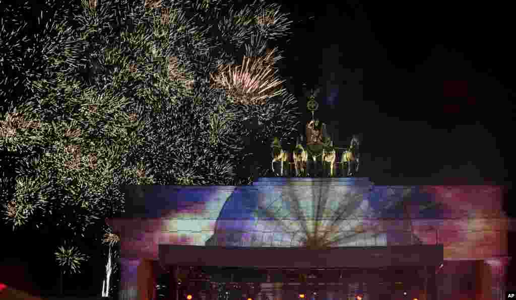 Berlin's famous landmark "Brandenburg Gate" is illuminated during the New Year's Eve celebrations in Berlin, Germany, Dec. 31, 2022.