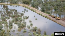 FILE- An aerial view of a road along flooded land caused by La Nina in the town of Goodooga, New South Wales, Australia, January 6, 2011. (REUTERS/Shawn Damian/File)
