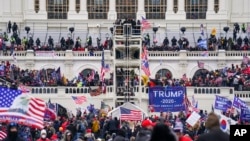 FILE - Insurrectionists loyal to President Donald Trump breach the Capitol in Washington, Jan. 6, 2021.