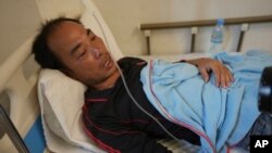 Survivor Zhu Pingfan from Hunan province, China, recuperates in a hospital bed, Sept. 24, 2022, Preah Sihanouk Province, Southwestern Cambodia after being rescued from a sinking boat days earlier. 