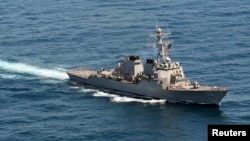 FILE - The guided-missile destroyer USS John S. McCain sails in formation during exercise Foal Eagle 2013 in waters west of the Korean peninsula in this March 21, 2013 handout photo courtesy of the U.S. Navy. 